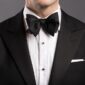 Man wearing a black bow tie with a tuxedo at a formal event