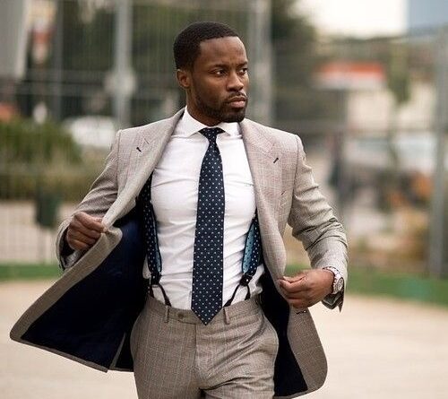 Man wearing suspenders with a formal suit and tie