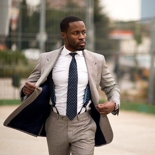 Man wearing suspenders with a formal suit and tie