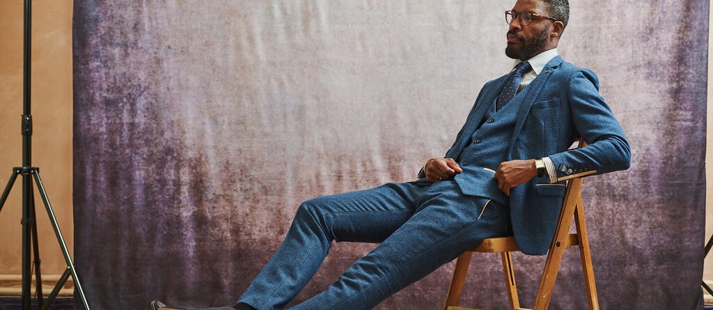 Man wearing a navy blue suit with tie and pocket square