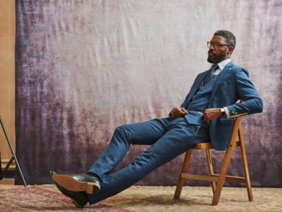 Man wearing a navy blue suit with tie and pocket square