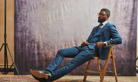 Man wearing a navy blue suit with tie and pocket square