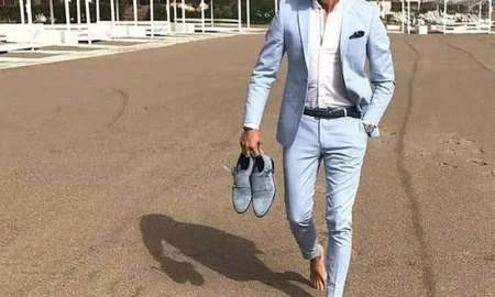 Men in light-colored suits at a summer outdoor wedding