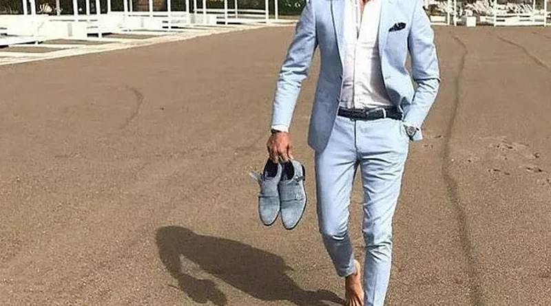 Men in light-colored suits at a summer outdoor wedding