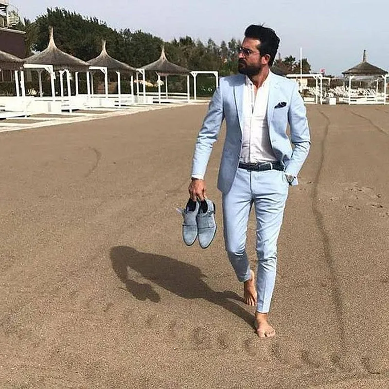 Men in light-colored suits at a summer outdoor wedding
