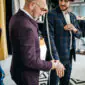 Tailor measuring a man for a suit jacket fitting