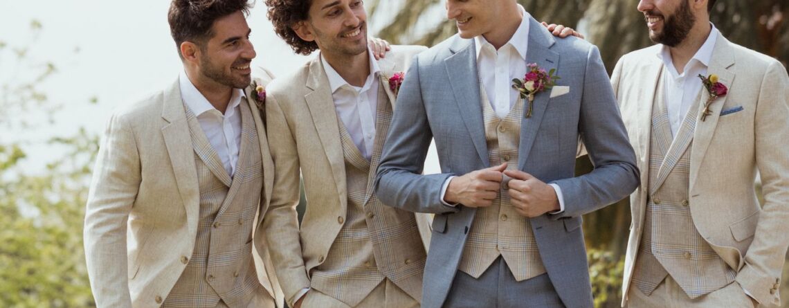 Men in wedding suits - groomsmen wearing linen suits at an outdoor wedding
