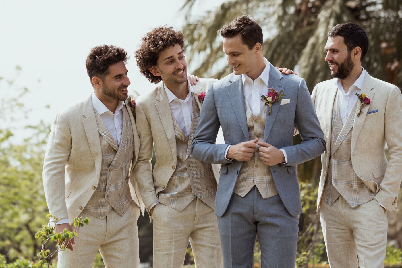 Men in wedding suits - groomsmen wearing linen suits at an outdoor wedding
